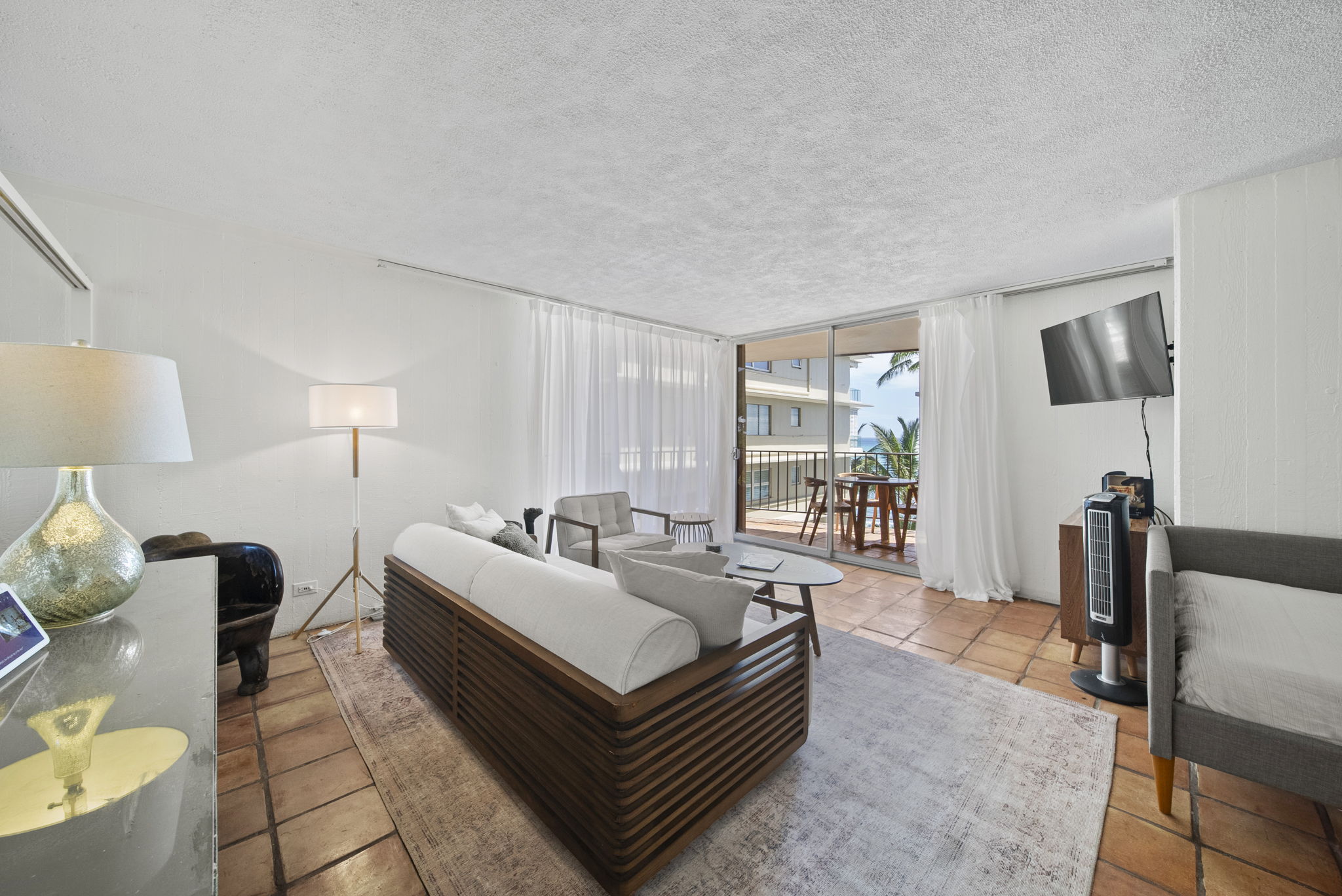 Bright living room opening onto the lānai