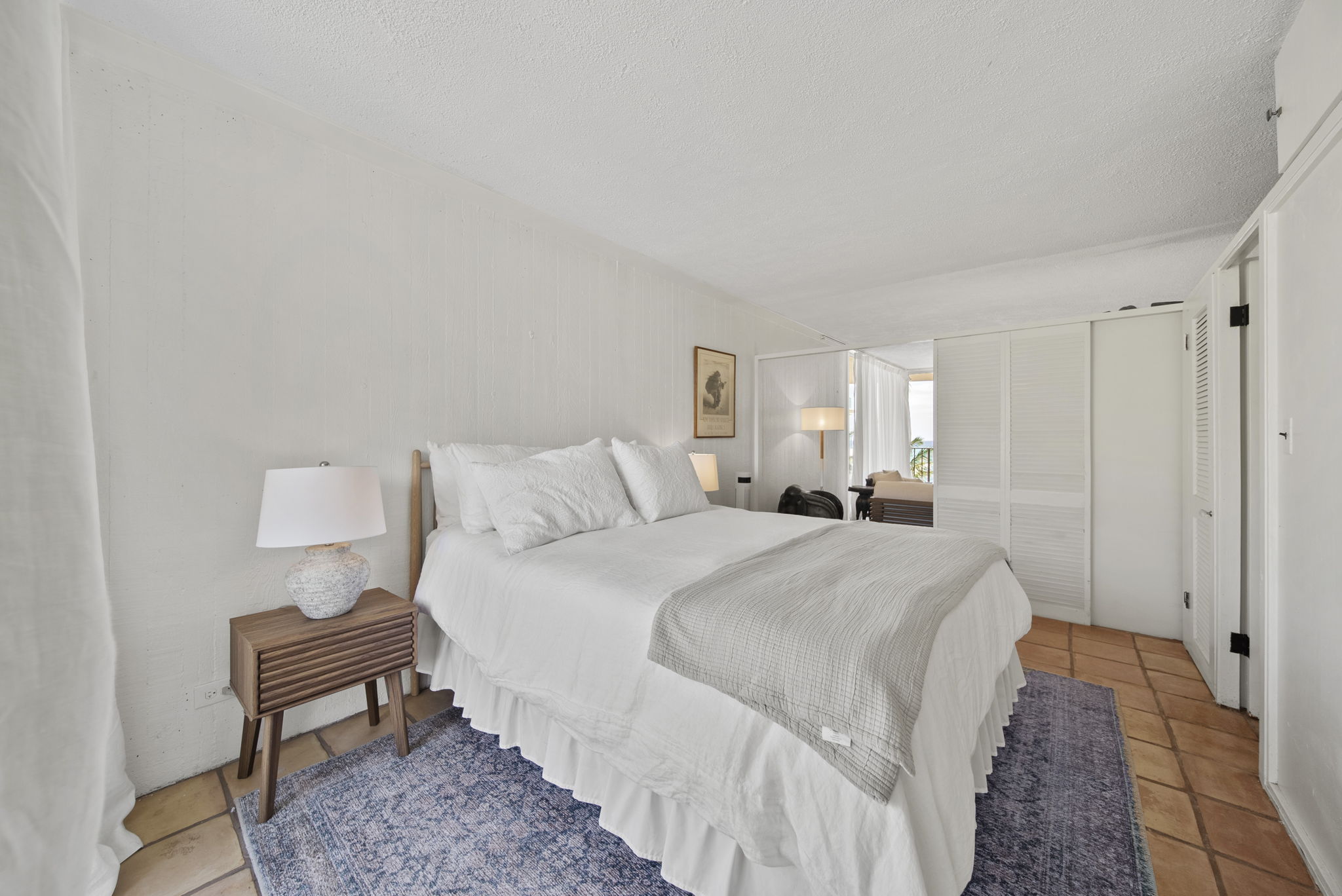 White bed with wood nightstands