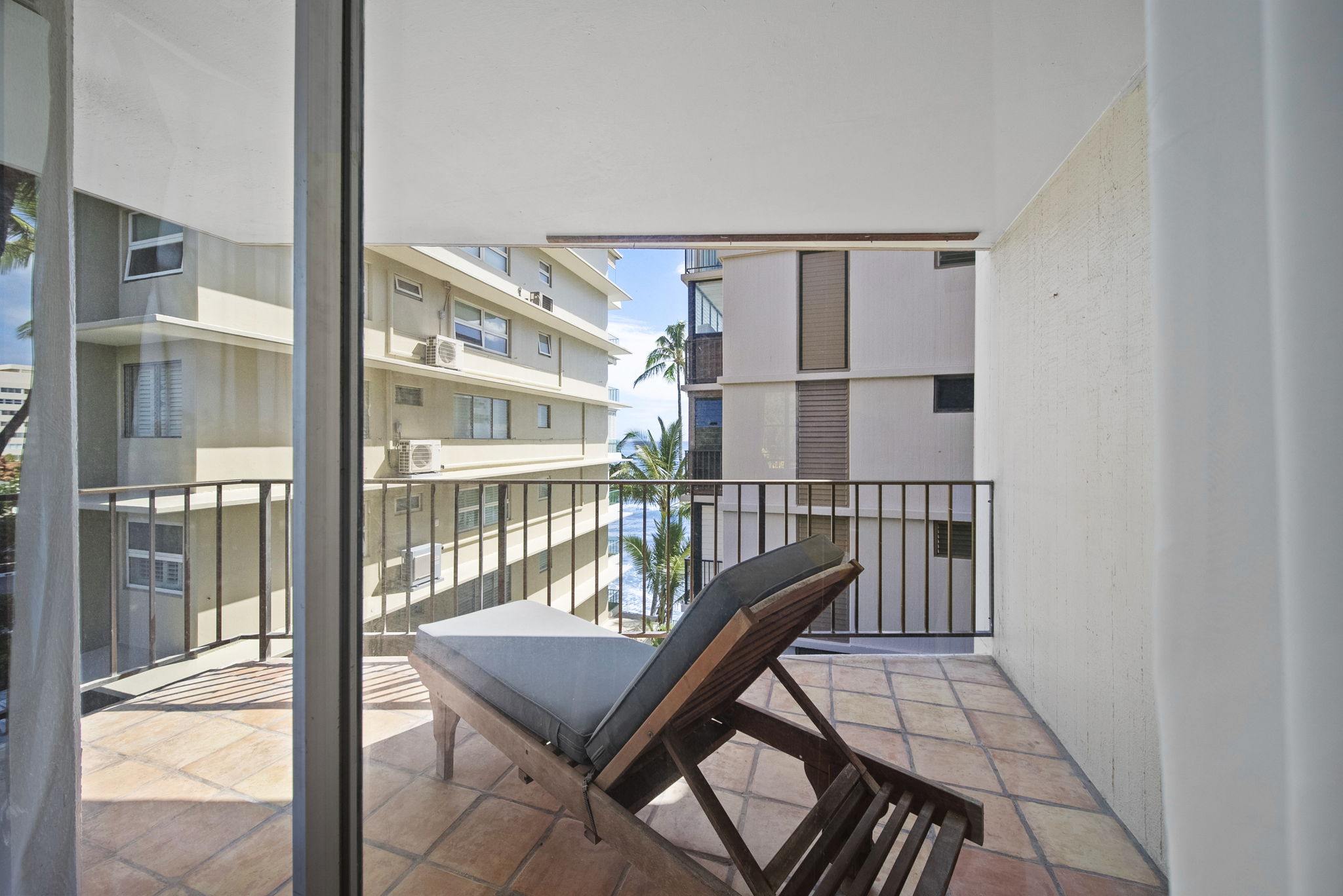 Lānai lounge chair facing an ocean view
