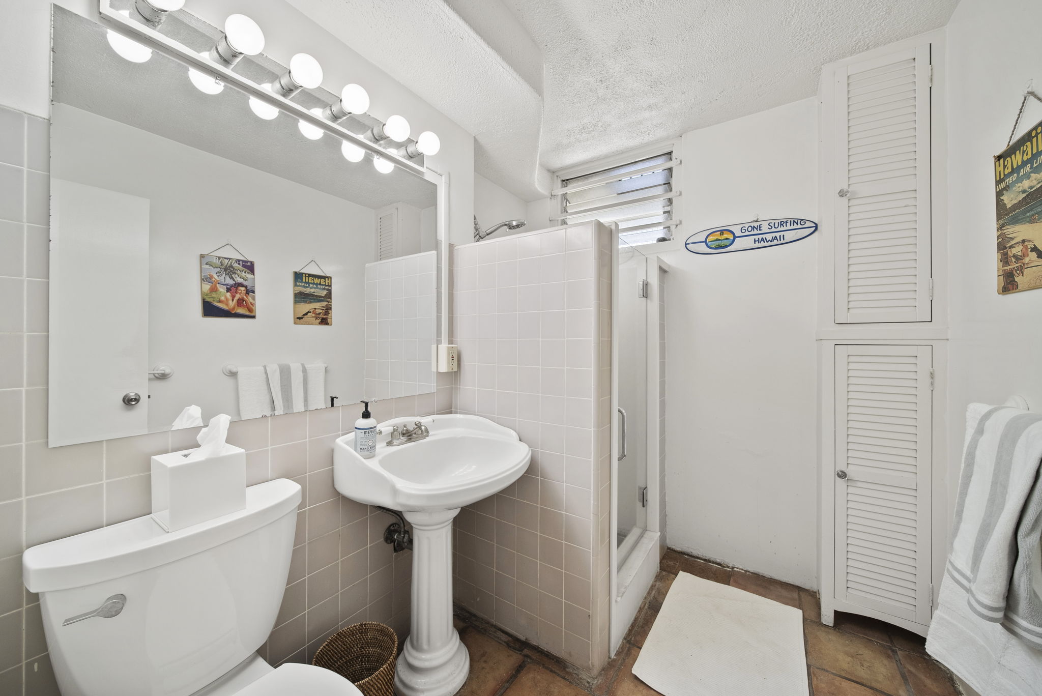 Bathroom with pedestal sink and shower