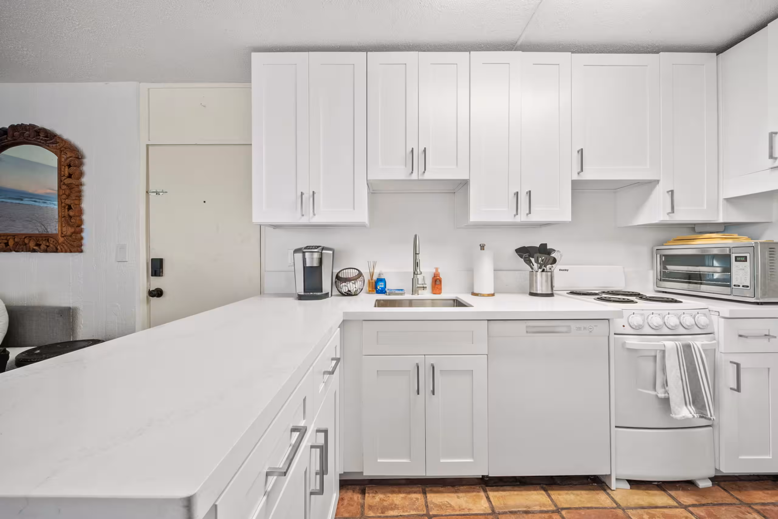 Updated white kitchen with full-size counters and appliances
